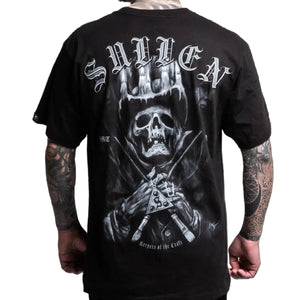 Black t-shirt with a graphic design of a skull and crossbones on the back, worn by a person.