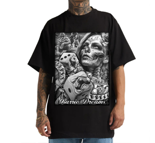 Black t-shirt with a graphic design of a skull, dice, and text 'Barrio Dreams' worn by a person.