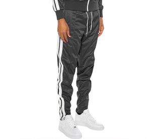 Person wearing gray tracksuit with white stripes on a white background