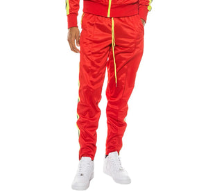 Person wearing a red tracksuit with yellow accents on a white background