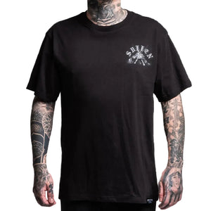 Black t-shirt with a logo worn by a person with tattoos on a white background