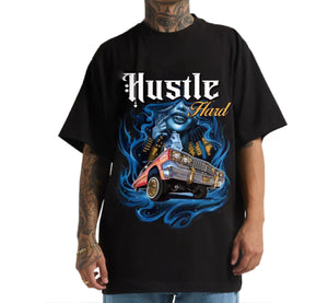 Black t-shirt with graphic design and 'Hustle Hard' text worn by a person.