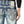 Load image into Gallery viewer, Close-up of a person wearing blue jeans with decorative stitching on a white background
