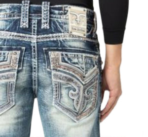 Close-up of a person wearing blue jeans with decorative stitching on a white background