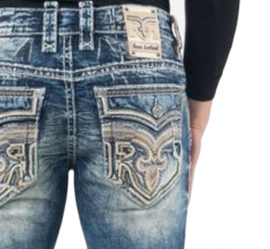Close-up of blue jeans with a Rock Revival logo on the pocket against a white background