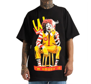 Black t-shirt with a graphic of a character in a yellow outfit and red text, on a white background.