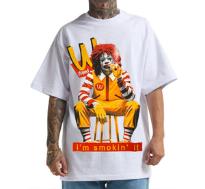 White t-shirt with a graphic of Ronald McDonald smoking a cigar and the text 'I'm smokin' it'.