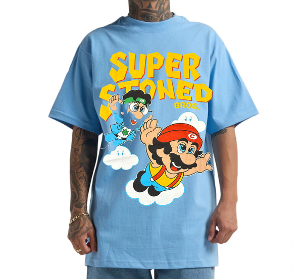 Person wearing a blue t-shirt with cartoon characters and 'Super Stoned Bros.' text.