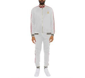 Man wearing a white tracksuit with red and black accents on a white background