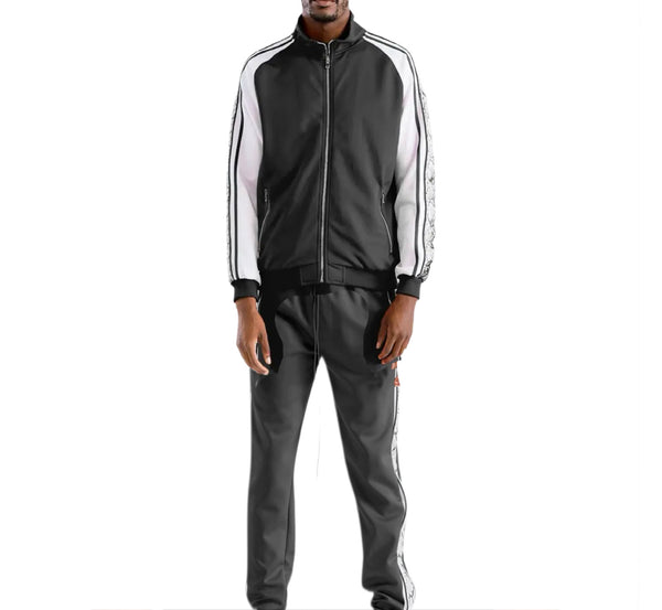 Person wearing a black and gray tracksuit with white stripes on a white background
